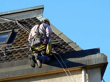 commercial roof cleaning services in naples fl cleaning roof with safety harnesses